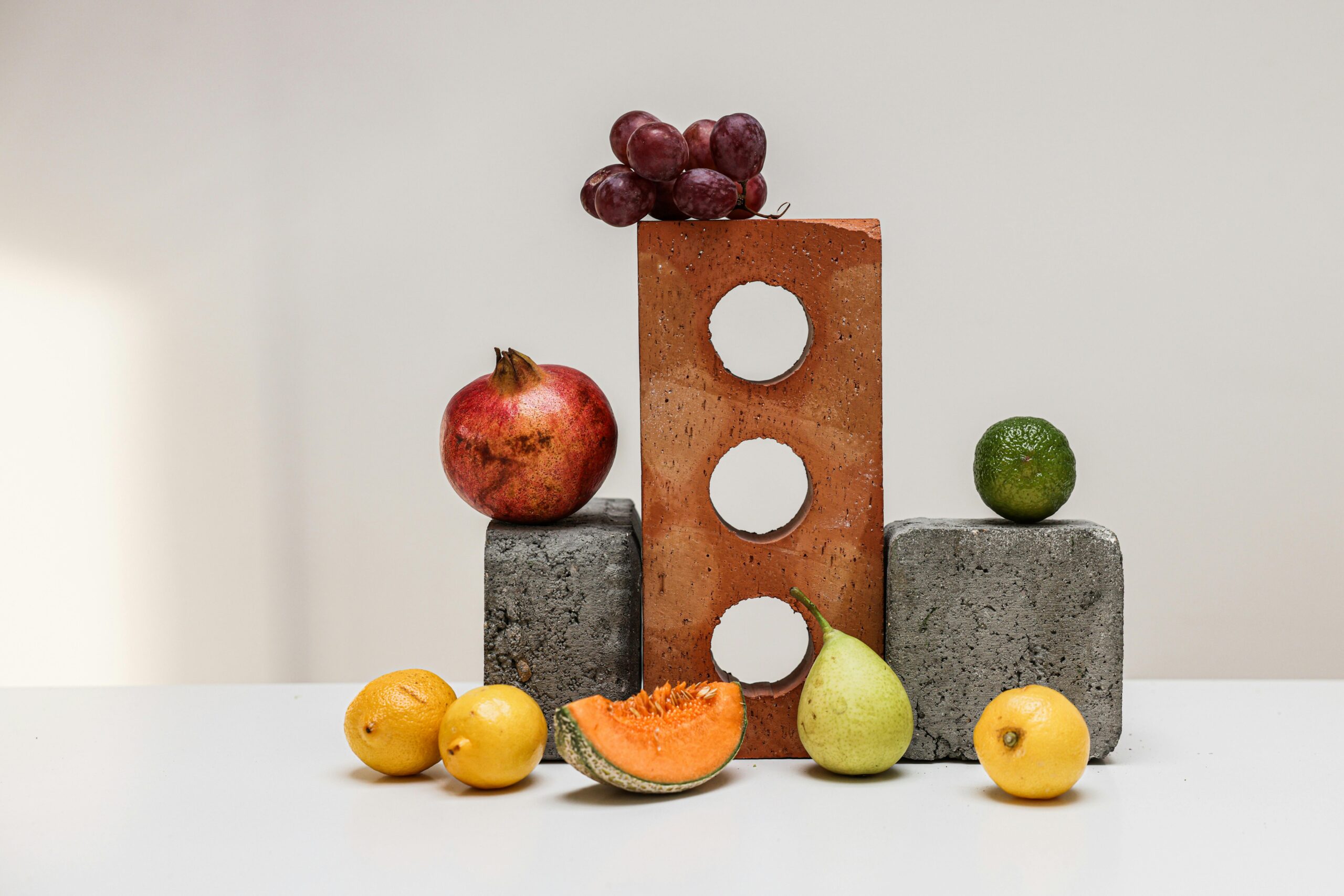 Vibrant display of fruits on concrete blocks, highlighting fresh and healthy choices.